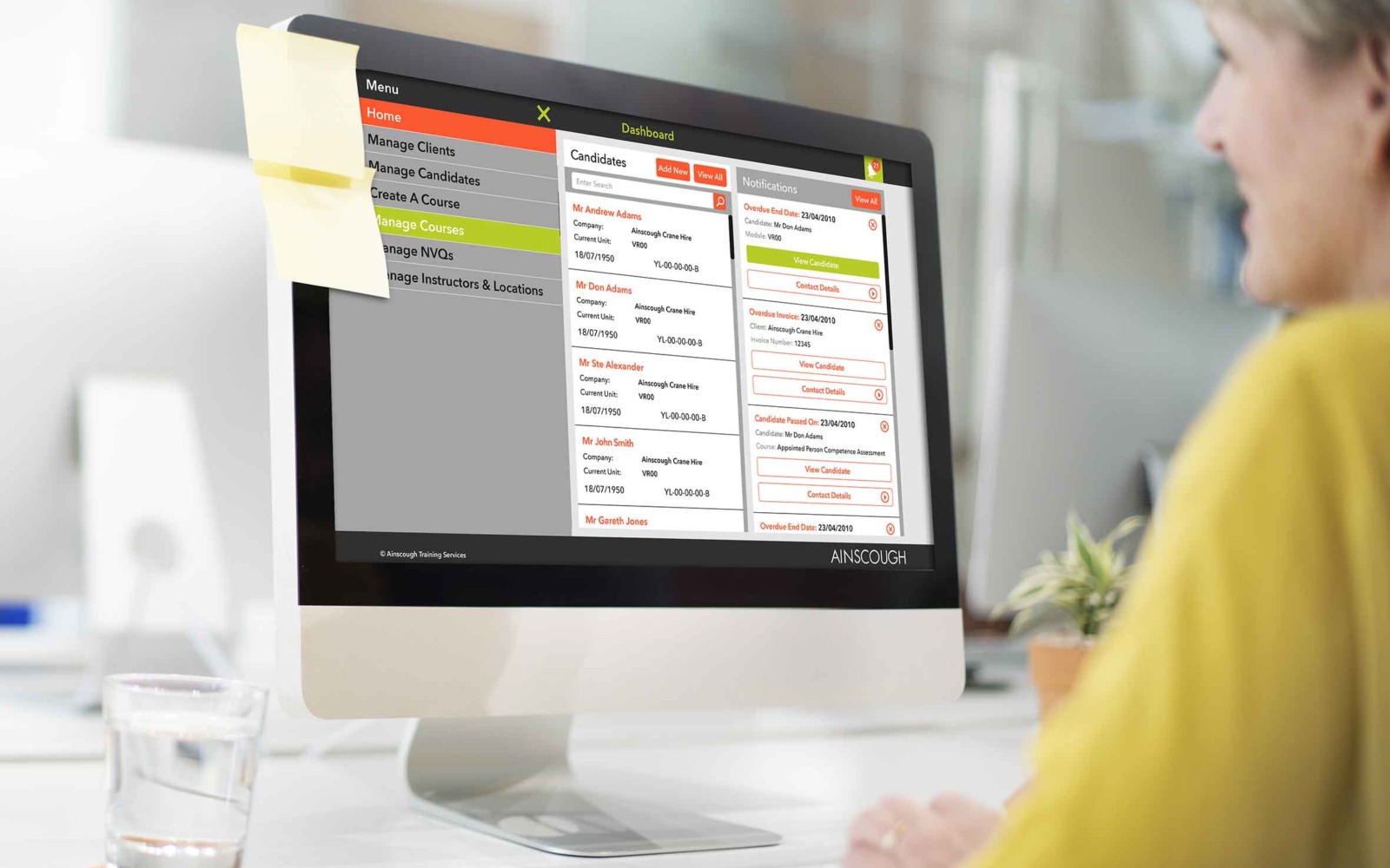 A woman using a computer displaying Ainscough Training Services' training CRM and workflow management software